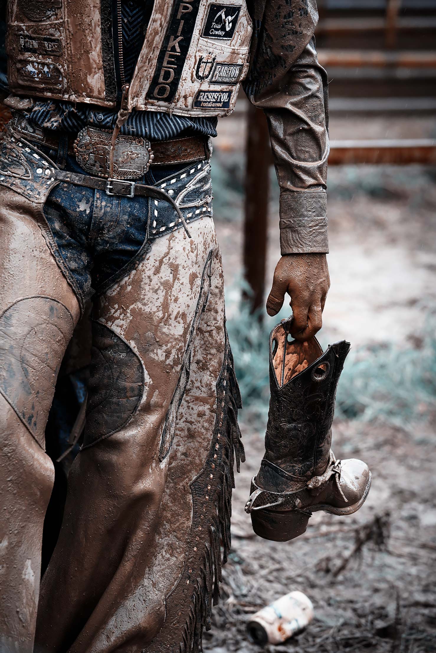 Cowboy Holding His Muddy Boot