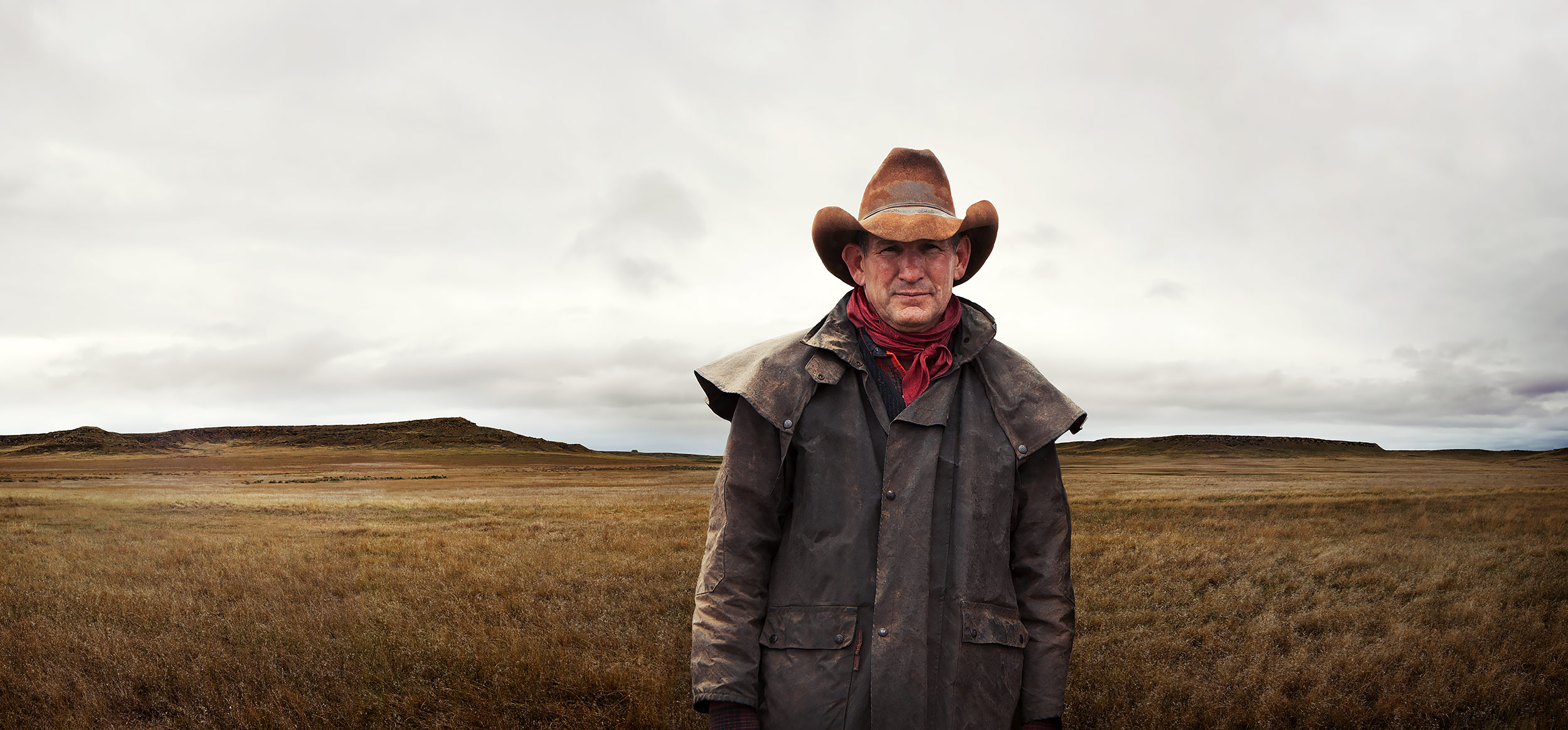 Portrait of a lone cowboy standing in a barren landscape