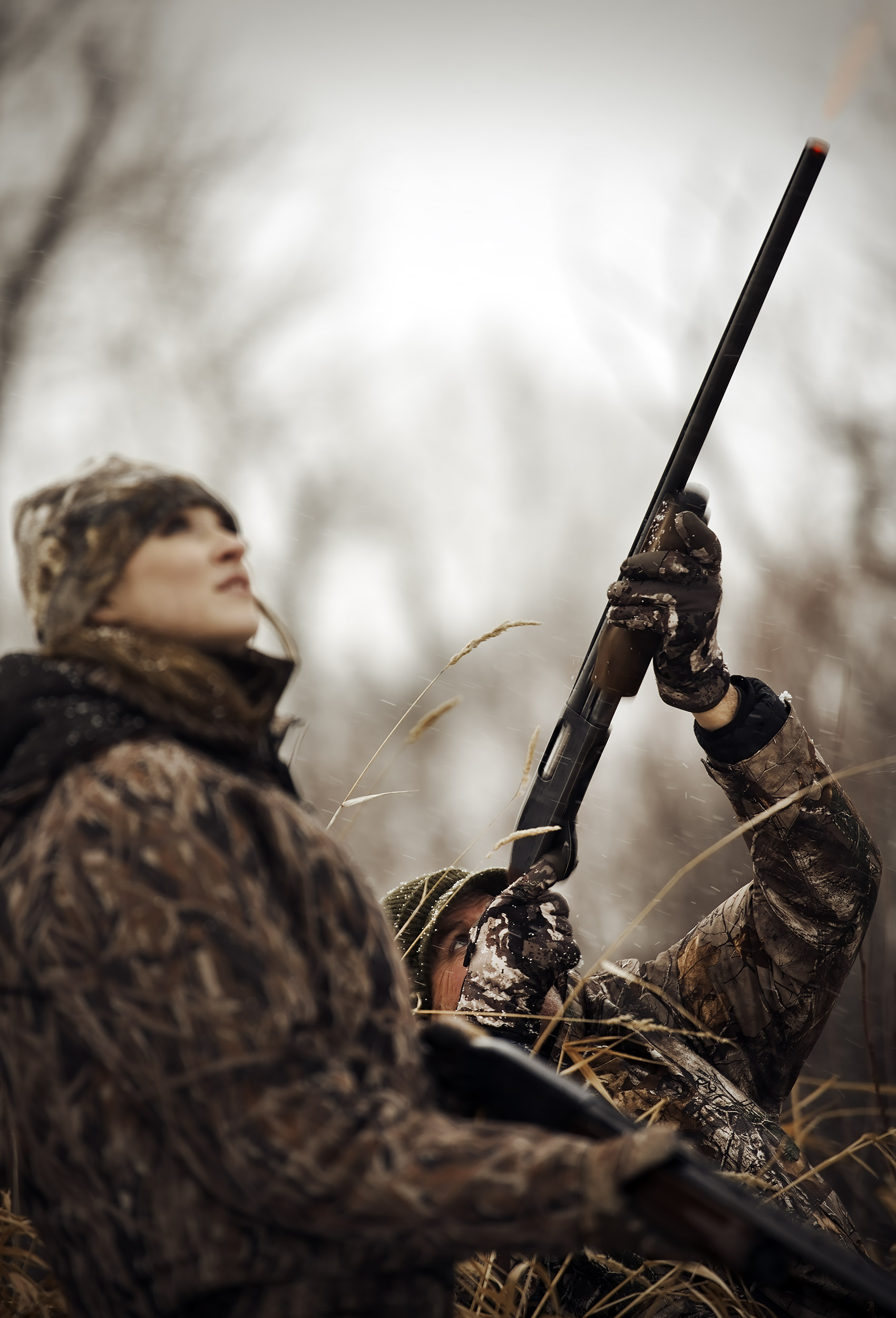 Father and daughter duck hunting together in a duck blind