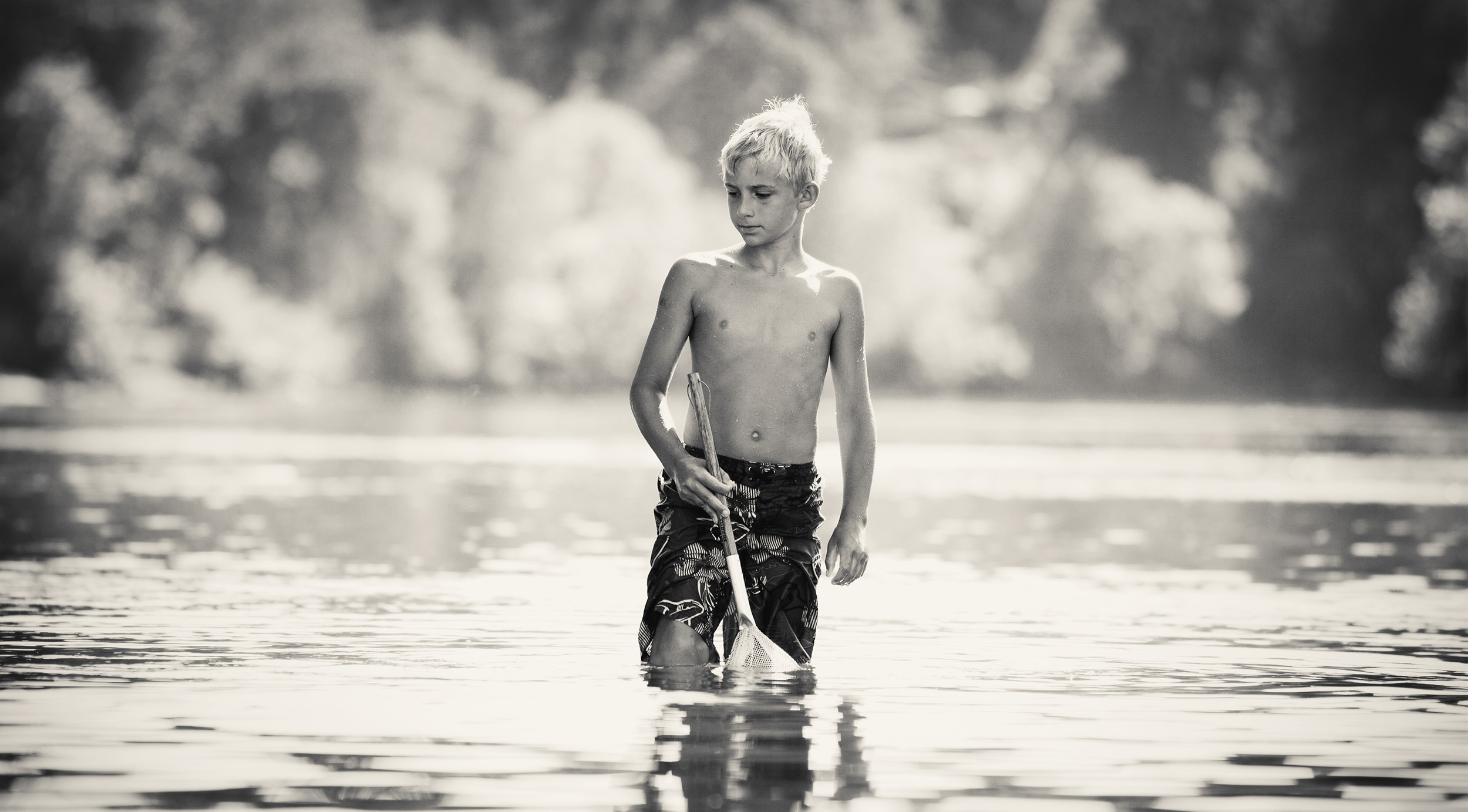Boy standing with a net in the Umpqua River