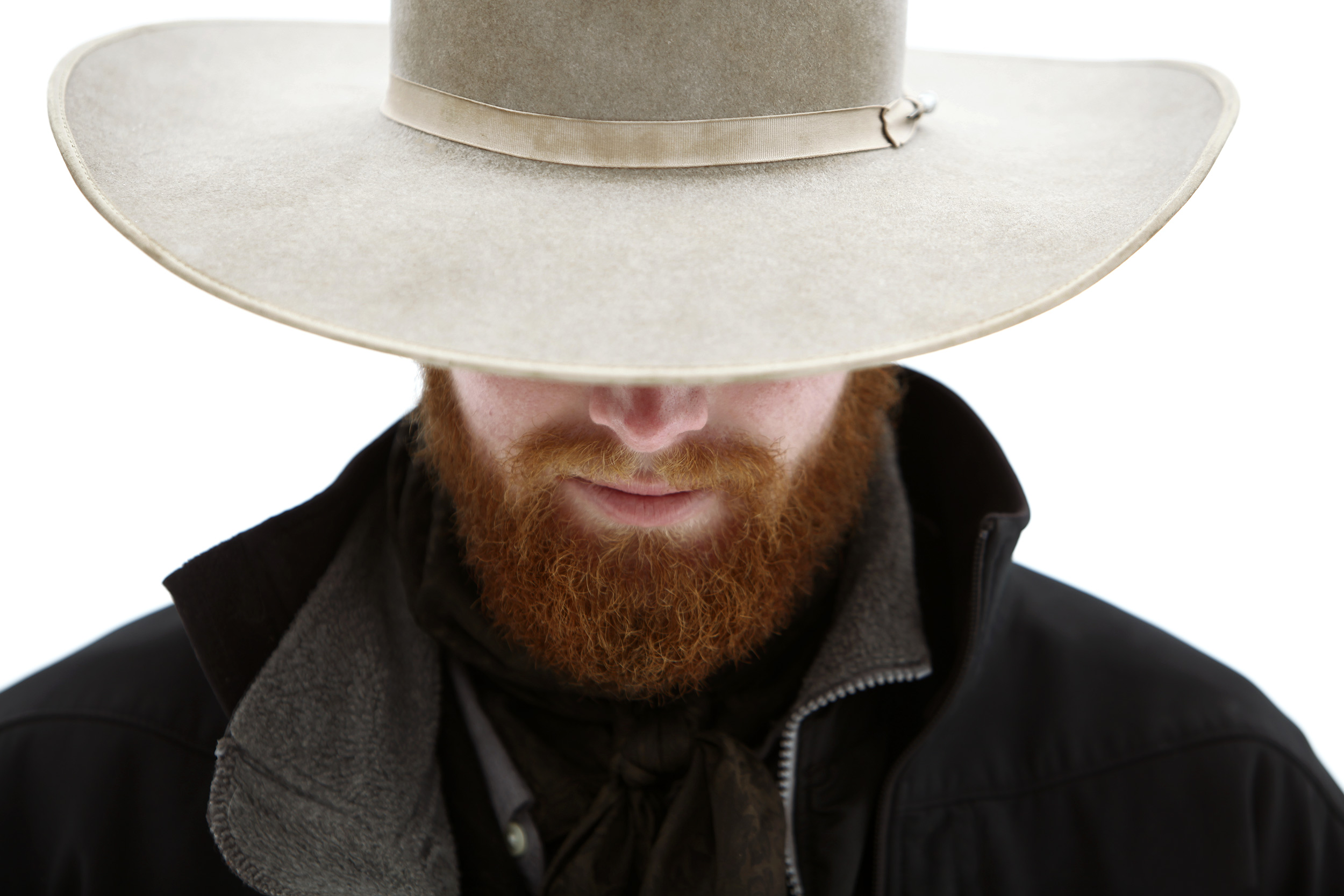 Portrait of a cowboy with a red beard looking down