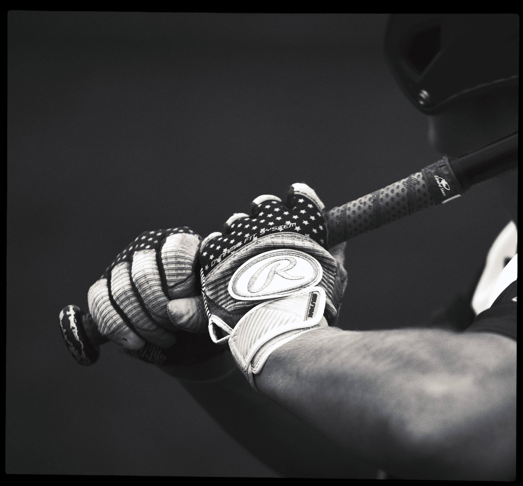 Detail of a baseball player holding a baseball bat