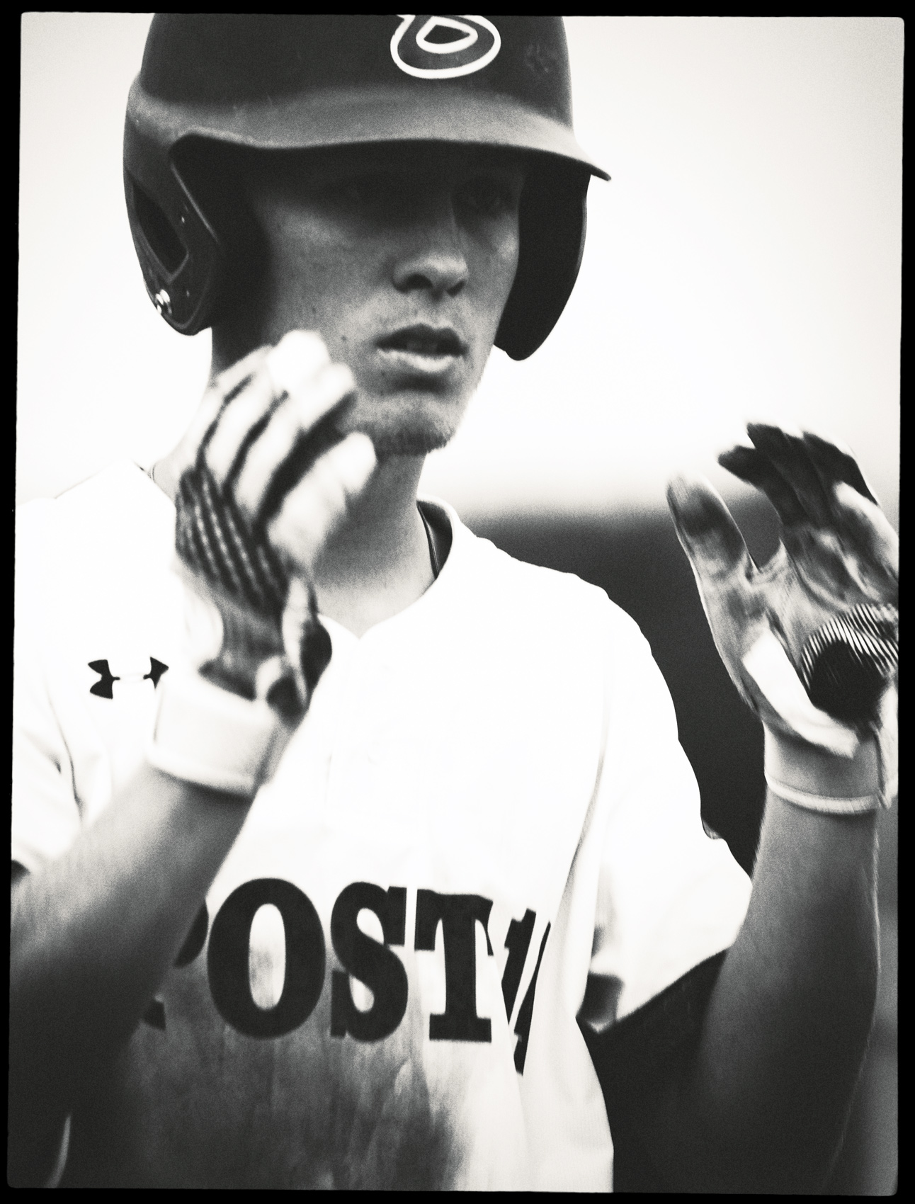 Baseball player with a helmet on in the on-deck circle