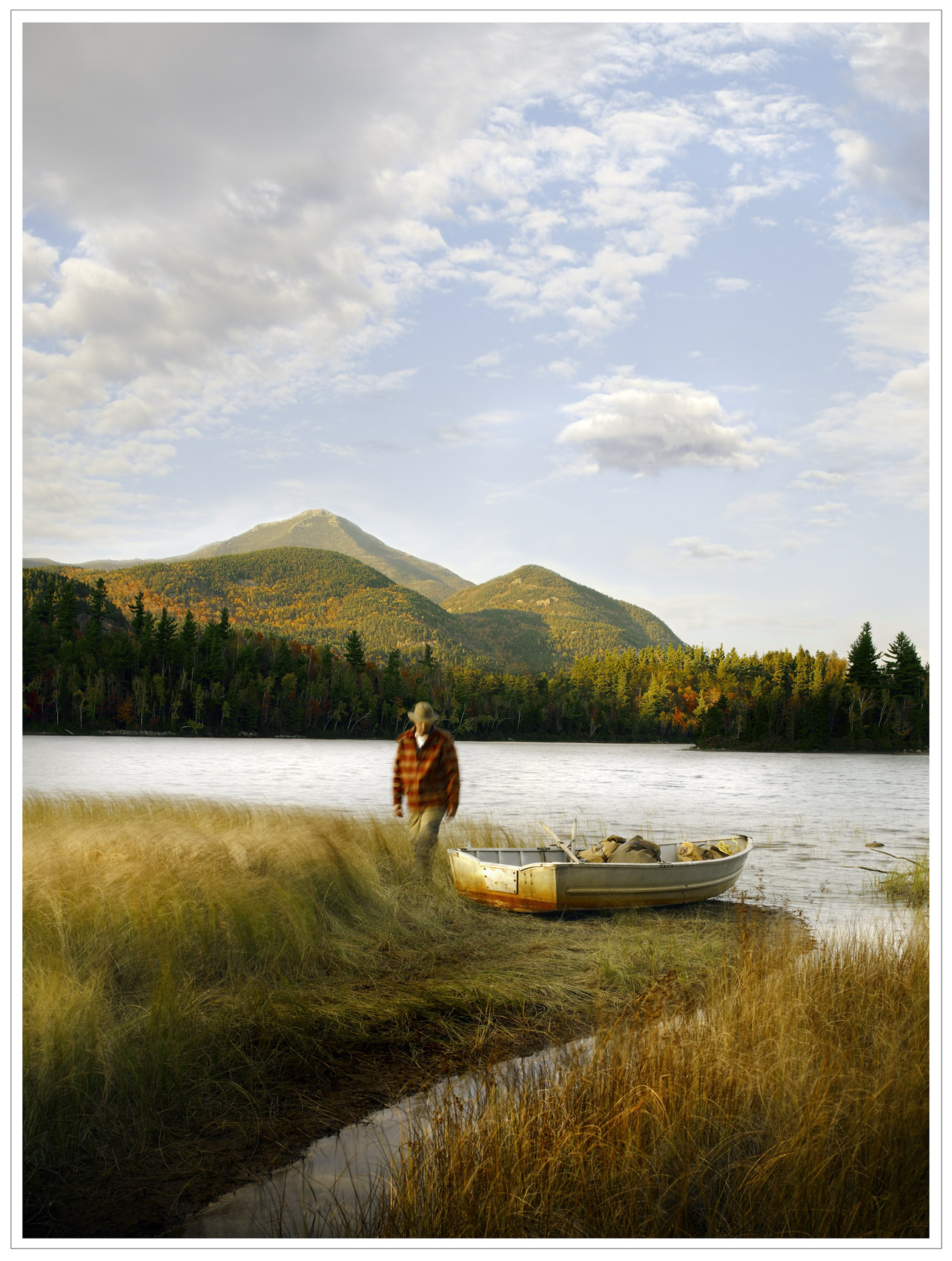 Man standing next to a rowboat in a lake - print campaign for CSX Corporation