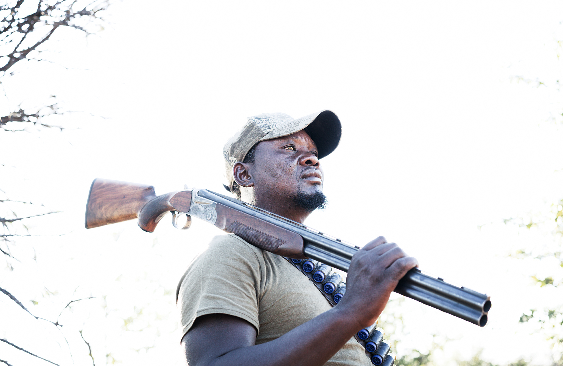 Hunting guide holding a shotgun in Namibia, Africa