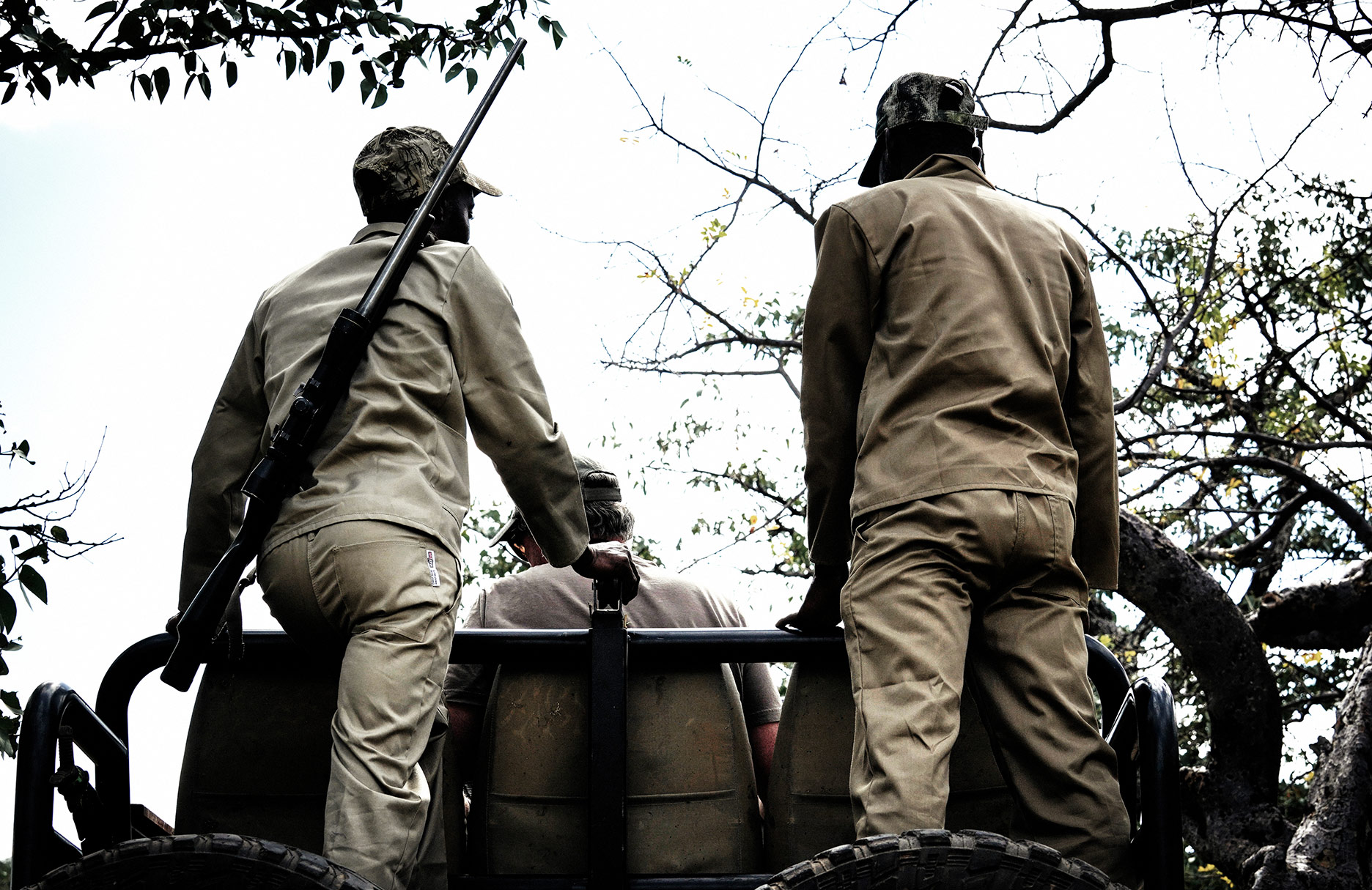 Hunting guides on the back of a Land Cruiser in Namibia, Africa