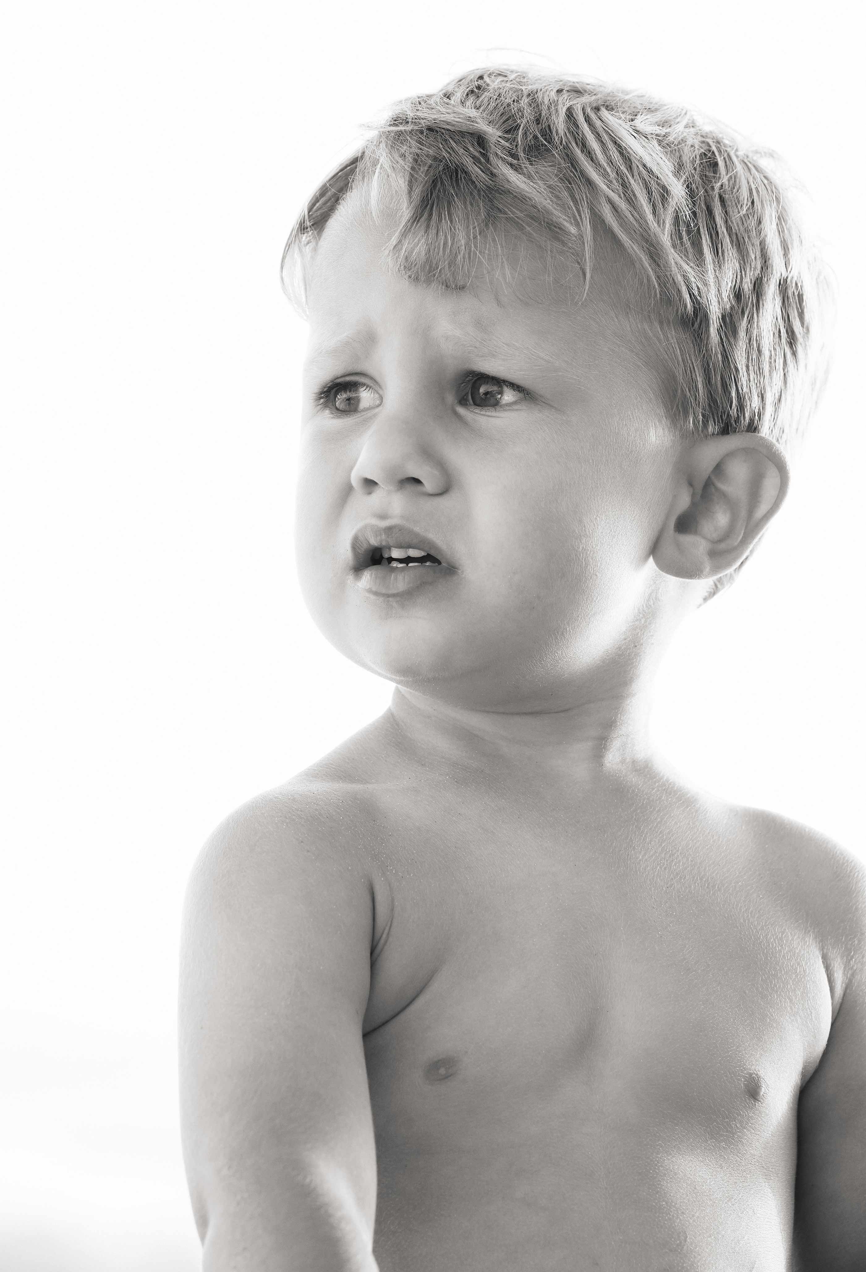 Black and white image of a shirtless young boy in Santa Barbara