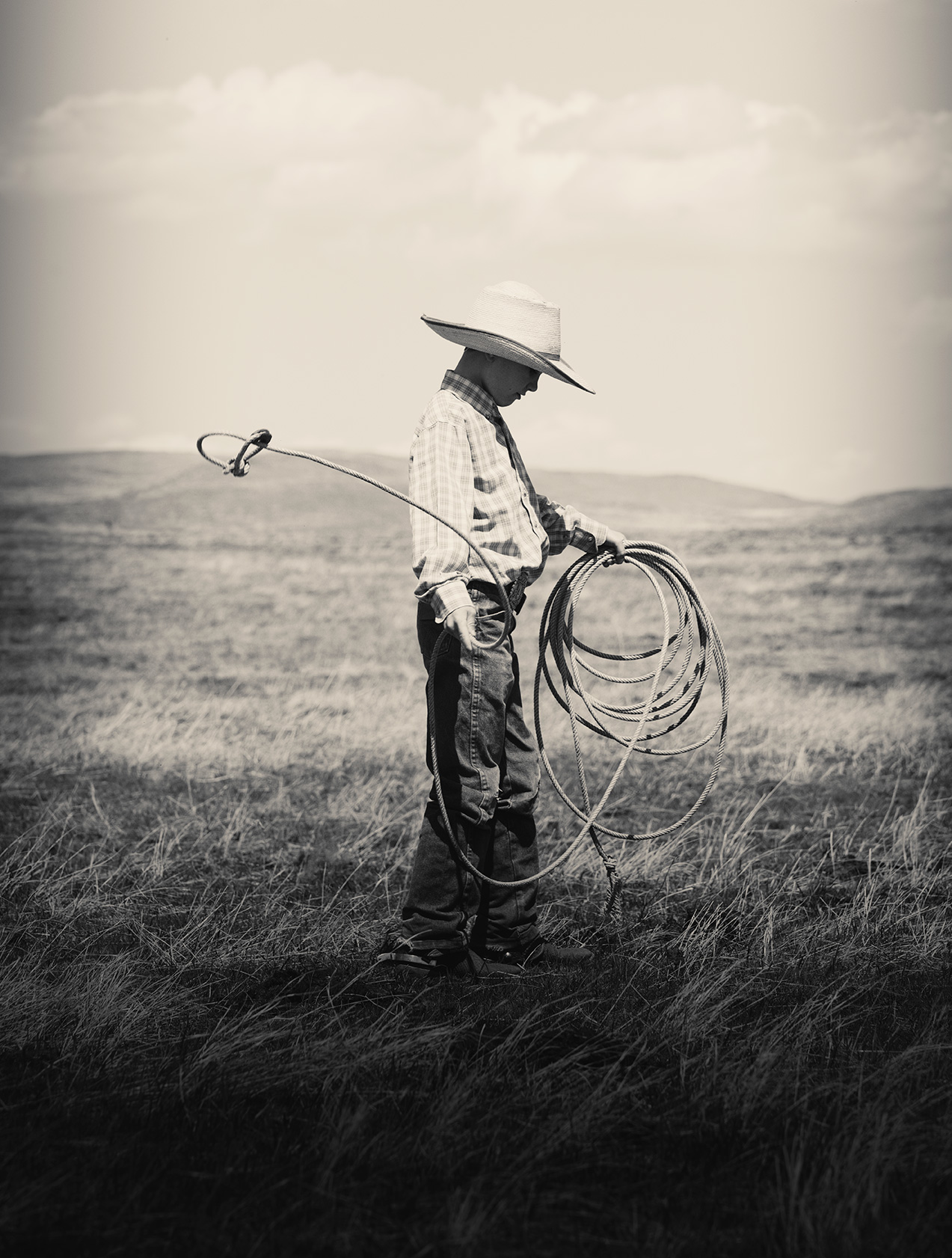 Young cowboy holding his rope on a ranch in Montana