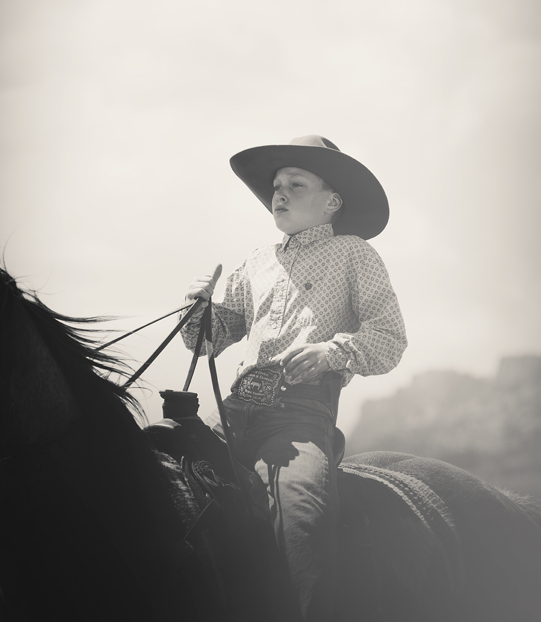 Young cowboy riding his horse on a ranch in Montana